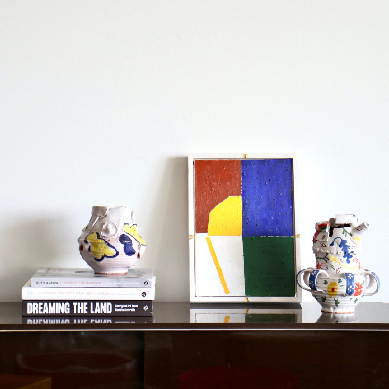 Handmade Ceramic Pentref Jug by Elin Hughes next to bold abstract painting