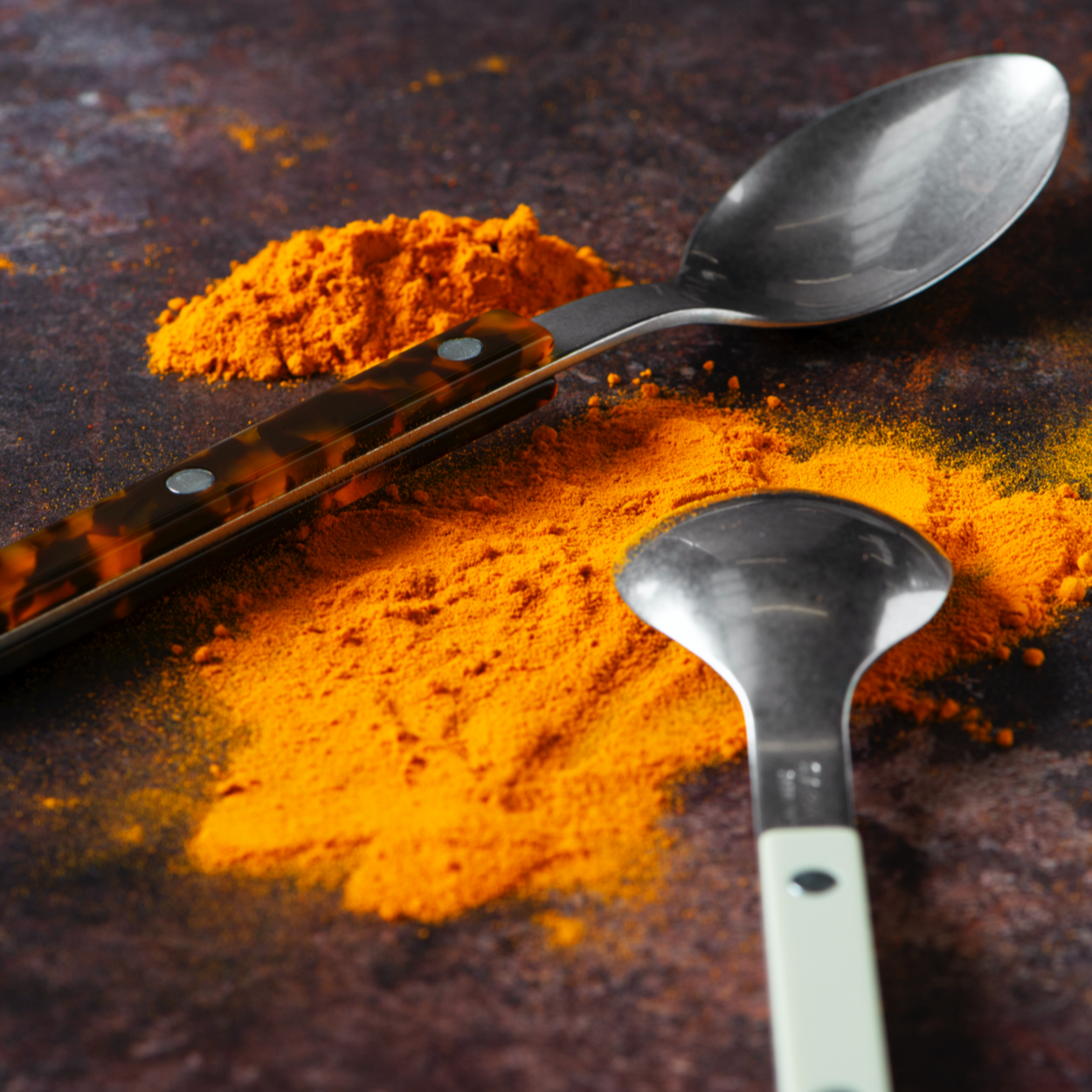 Close up Mixed colour Sabre Paris Bistrot Cutlery with spices