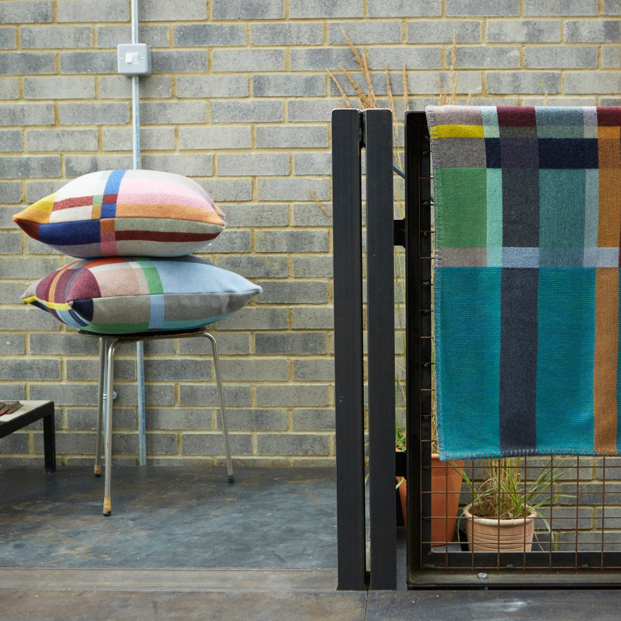 Premium Merino wool cushion cover in Lloyd with blankets in industrial apartment