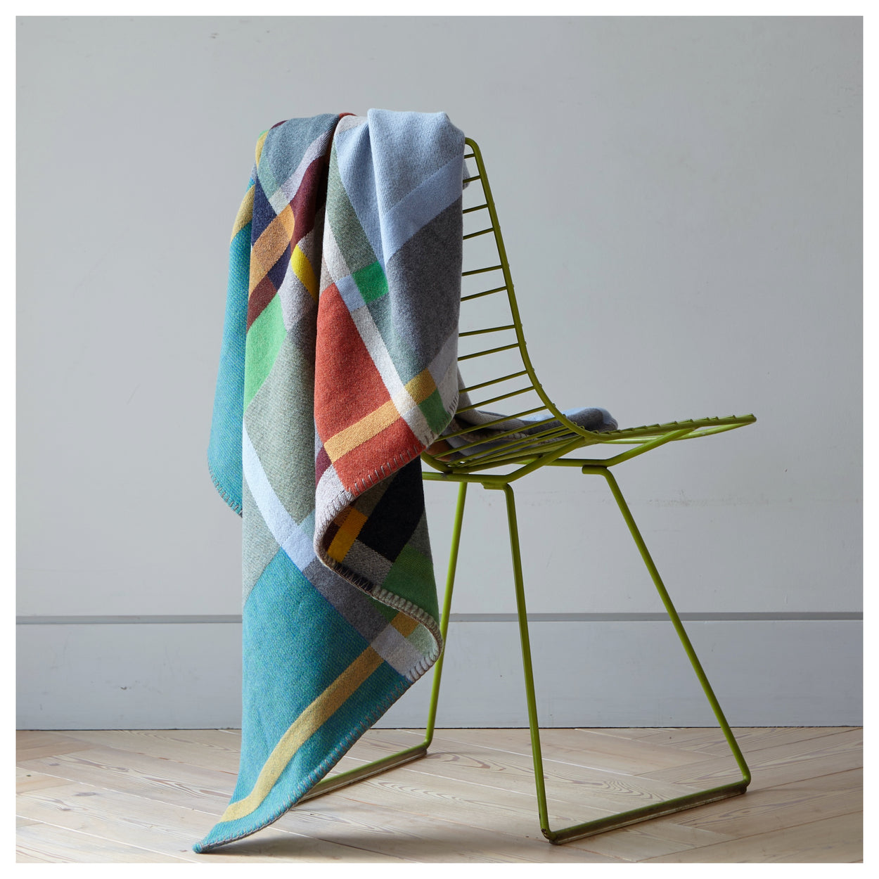 Wallace Sewell Fieldon blanket draped over green chair.