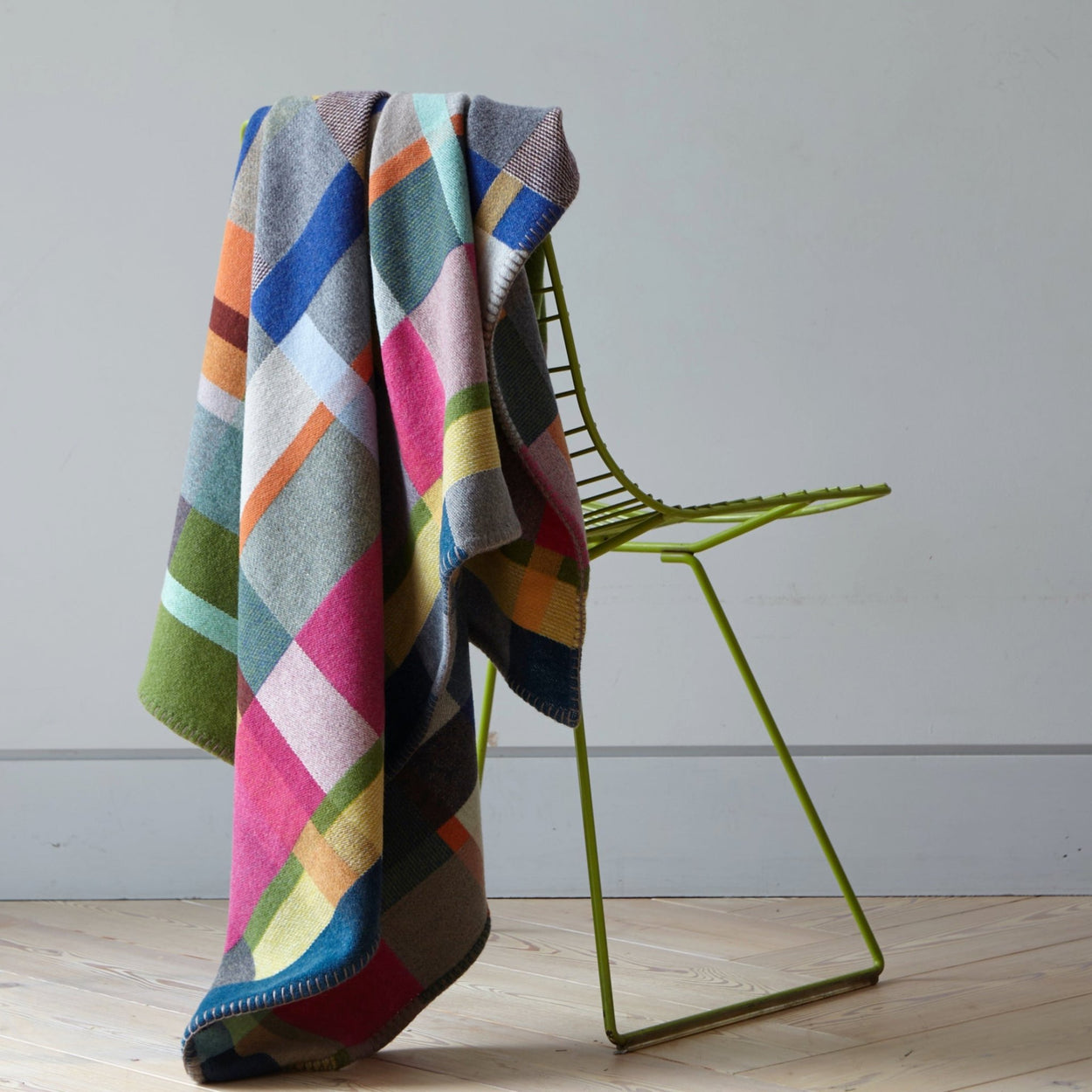 Premium Australian Merino Wool Throw Blanket in bright pink and blue on chair