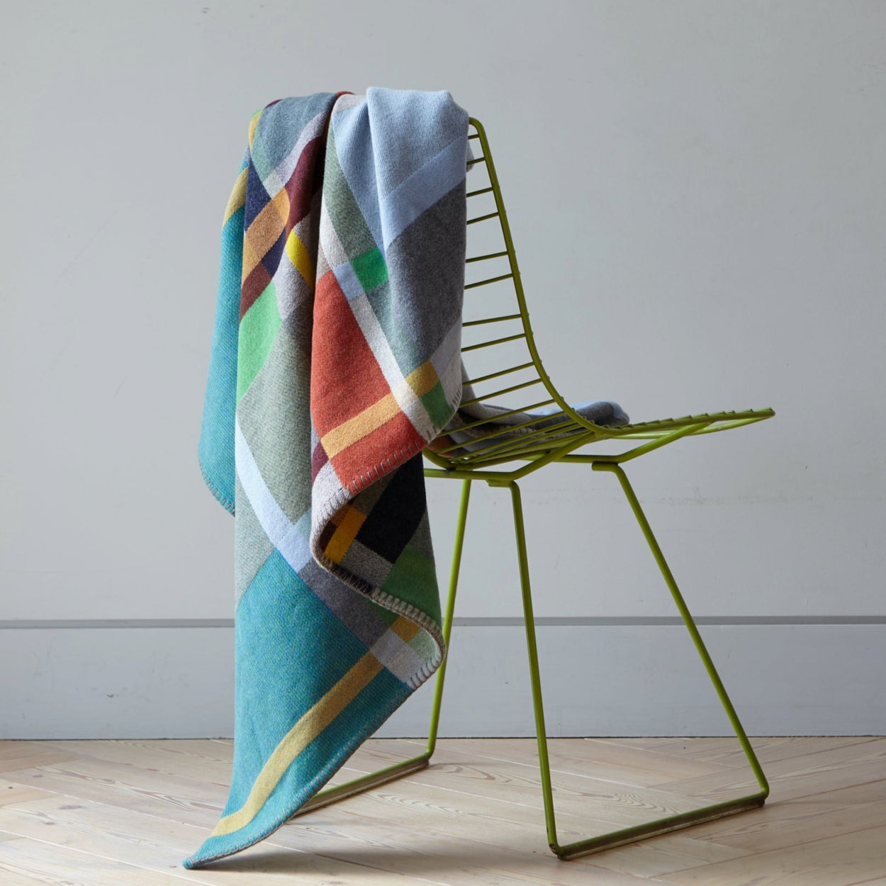 Fieldon Premium Merino Lambswool blanket on back of green chair