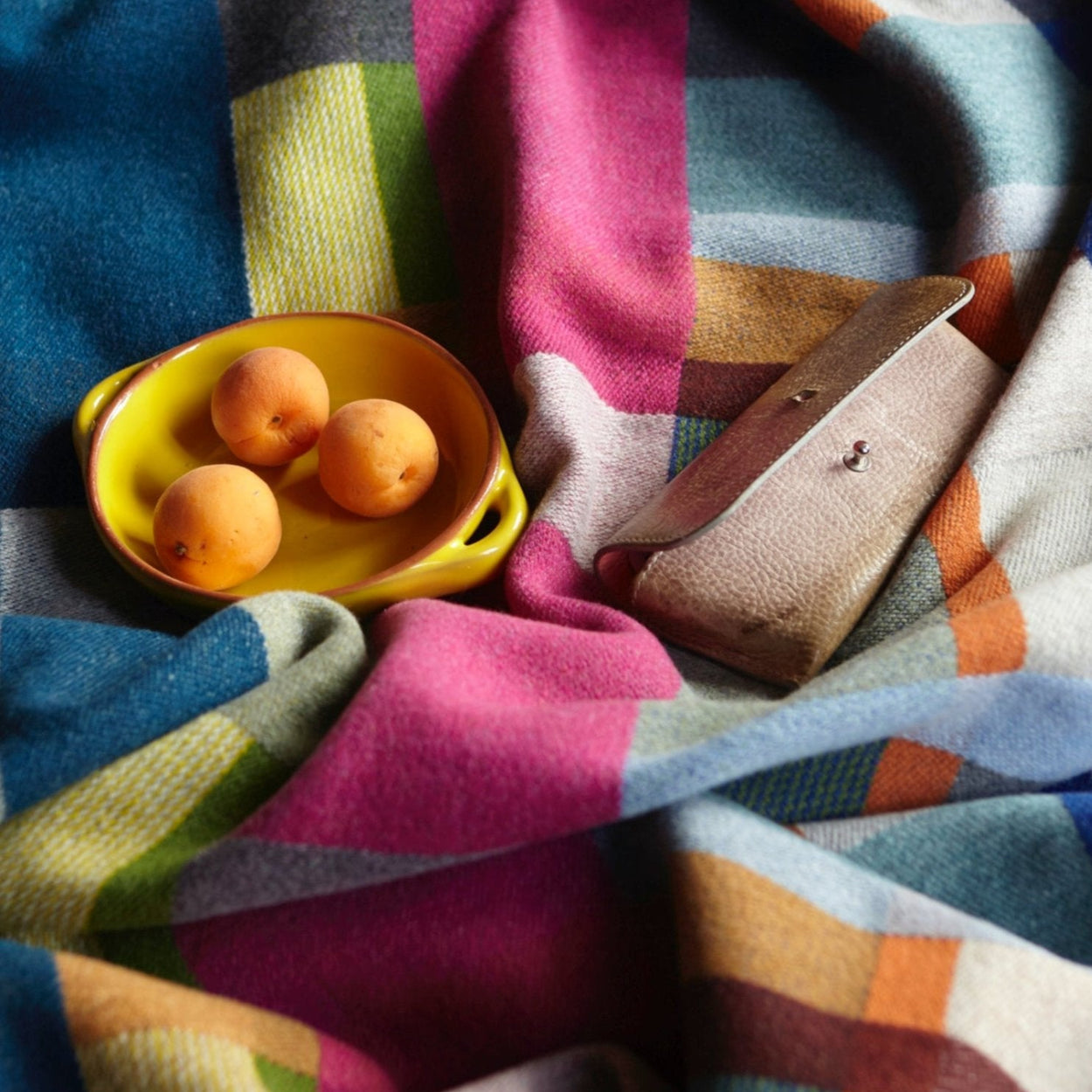 Premium Australian Merino Wool Throw Blanket in bright pink and blue, with fruit on bed