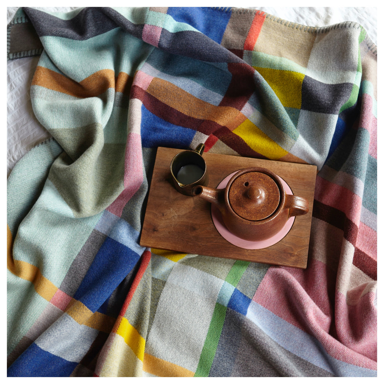 Premium Merino Lambswool Throw Blanket - Lloyd on bed with tea set