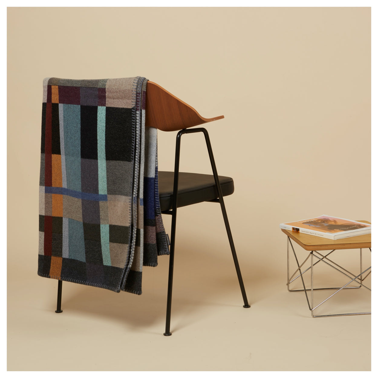 Premium Merino Lambswool throw blanket - Erno Blue, Grey & Grape block on a chair with side table