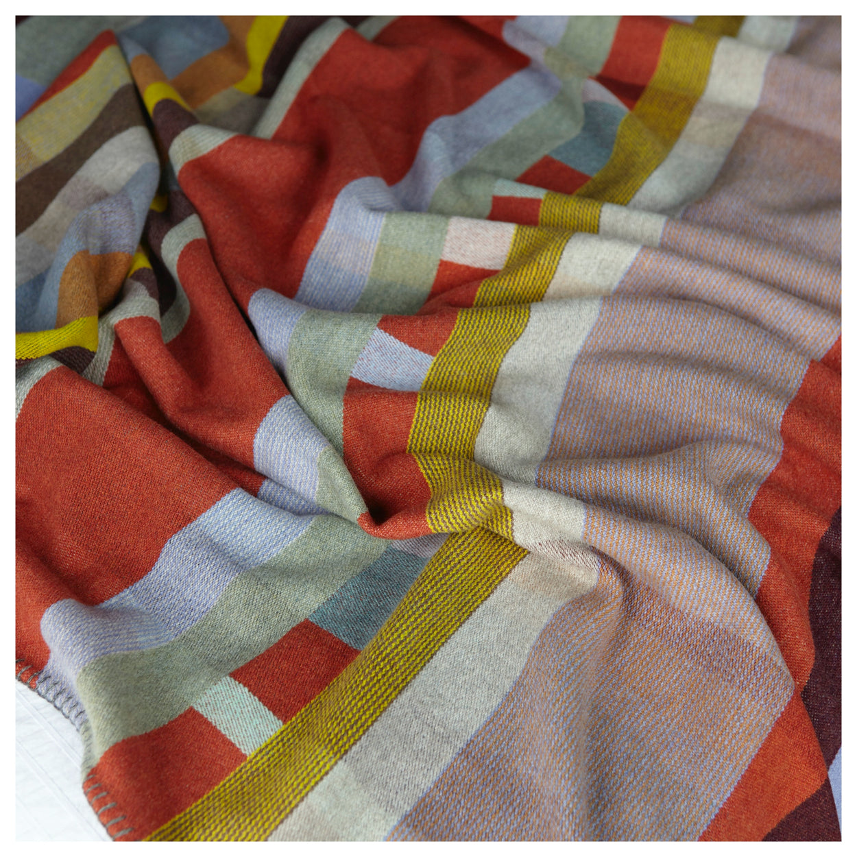 Cecil Orange and brown Premium Merino Lambswool wool throw blanket on bed