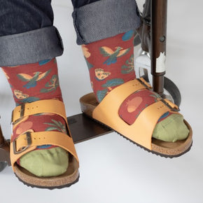 Woman in wheelchair with yellow sandals wearing Bonne Maison Volcano Socks