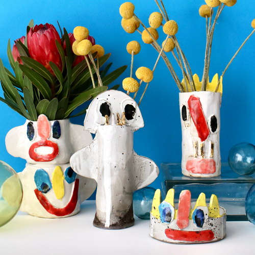 Group of Florian tanzer ceramic vases against blue backdrop