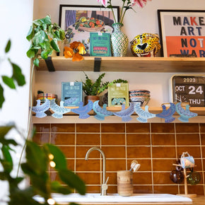 Kitchen counter with decorative items, plants, and a calendar.