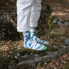 Person in forest wearing white jeans wearing Bonne Maison Trompe L'oeil socks 