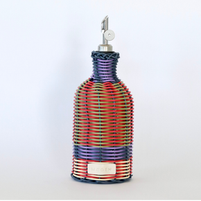 Decorative bottle with woven design and metallic nozzle on a white background