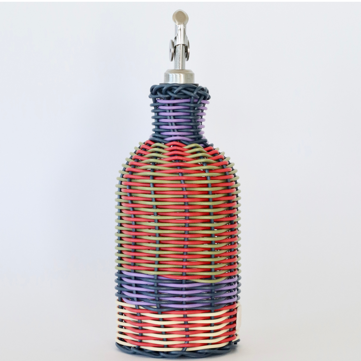 Decorative bottle with woven design and metallic nozzle on a white background