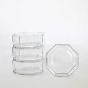 Set of clear glass hexagonal containers on a white background