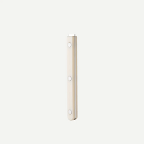 A slim, rectangular closeup of a Sabre Paris Bistrot Serving Set handle, finished in a warm cream or off-white color, shown against a solid light gray background.