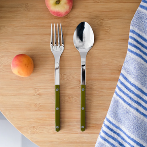 Sabre Bistrot Serving Set - Fern Green on wood table with striped blue towel and peaches.