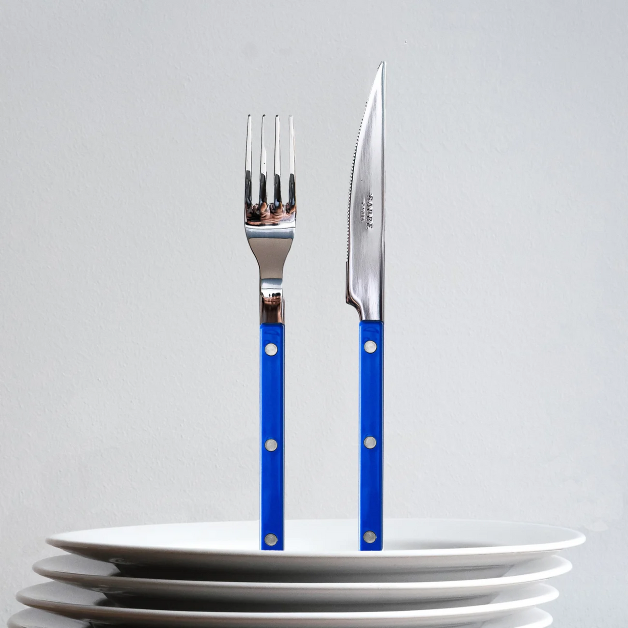 Sabre Bistrot Cutlery 4 Piece Set - Lapis Blue on plate