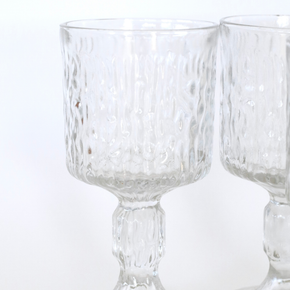 Close up of Ravenhead Icy Bark Siesta Wine glasses against a white background.