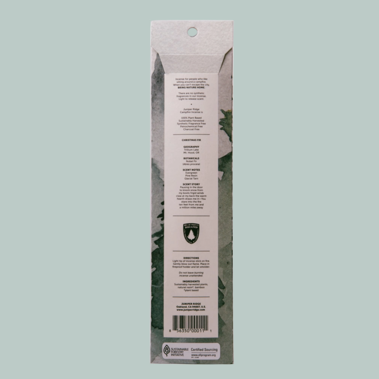 The back of a tall, narrow product package shown against a solid light gray background. The package has a white center label with black text, a small green shield logo, and a barcode near the bottom.