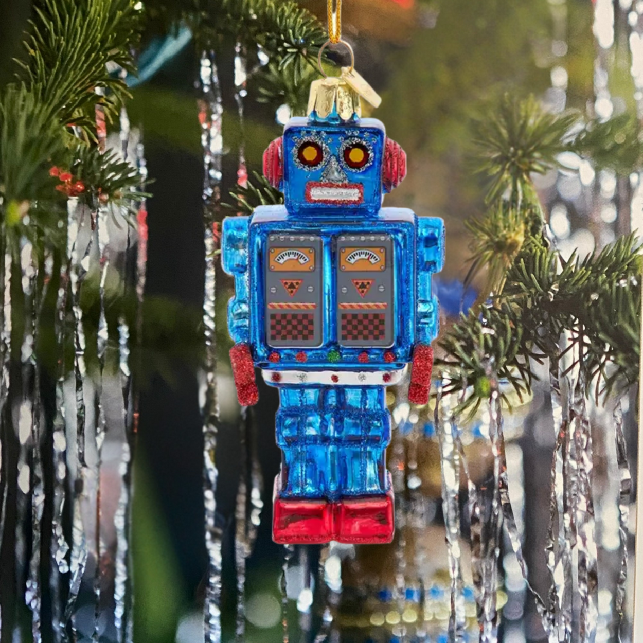 Decorative robot ornament hanging on a Christmas tree.