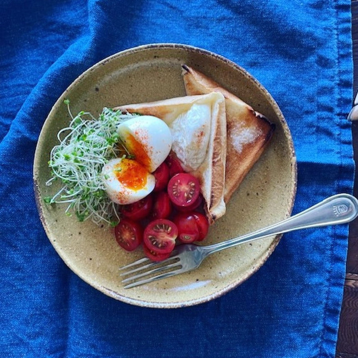 Japanese Jupiter Dinner Plate with food on a blue napkin