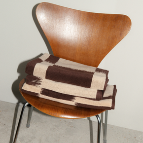 Autumn Sonata Karin towel folded on wooden chair.