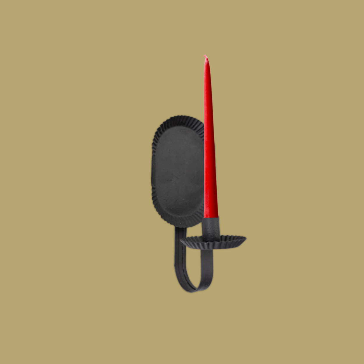 Black candle holder with a red candle on a beige background
