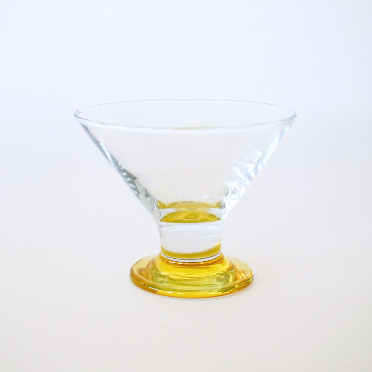 Clear glass with a yellow base on a white background