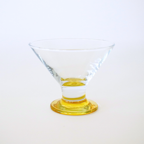 Clear glass with a yellow base on a white background