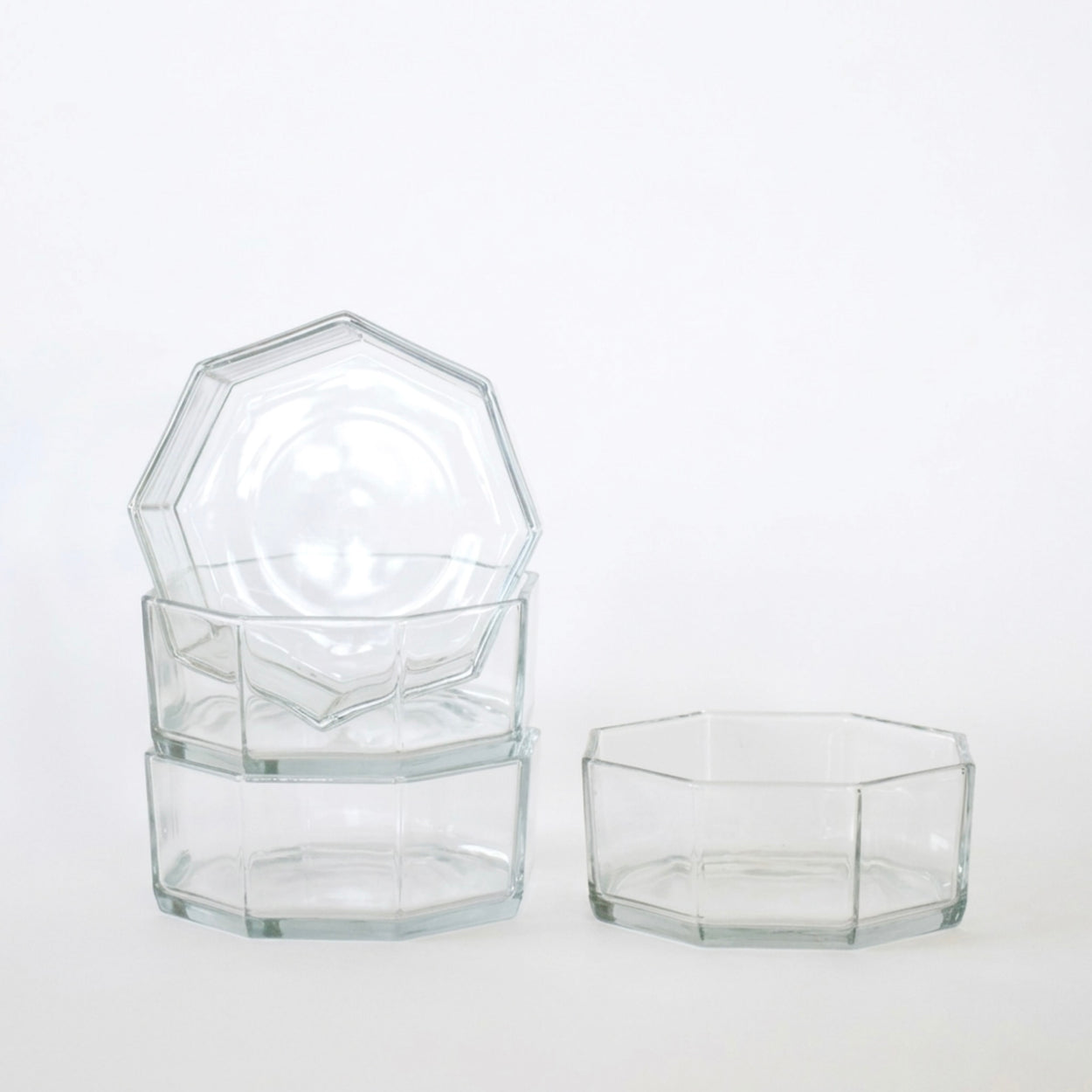 Set of hexagonal glass containers on a white background