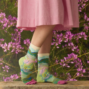 Woman in pink skirt in garden wearing Garden Bonne Maison socks 