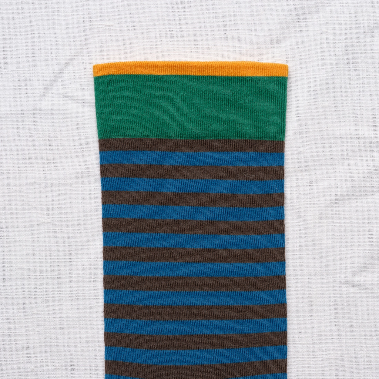 Close up of Bonne Maison Blue Black Stripe socks against a white backdrop.