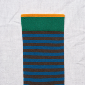 Close up of Bonne Maison Blue Black Stripe socks against a white backdrop.