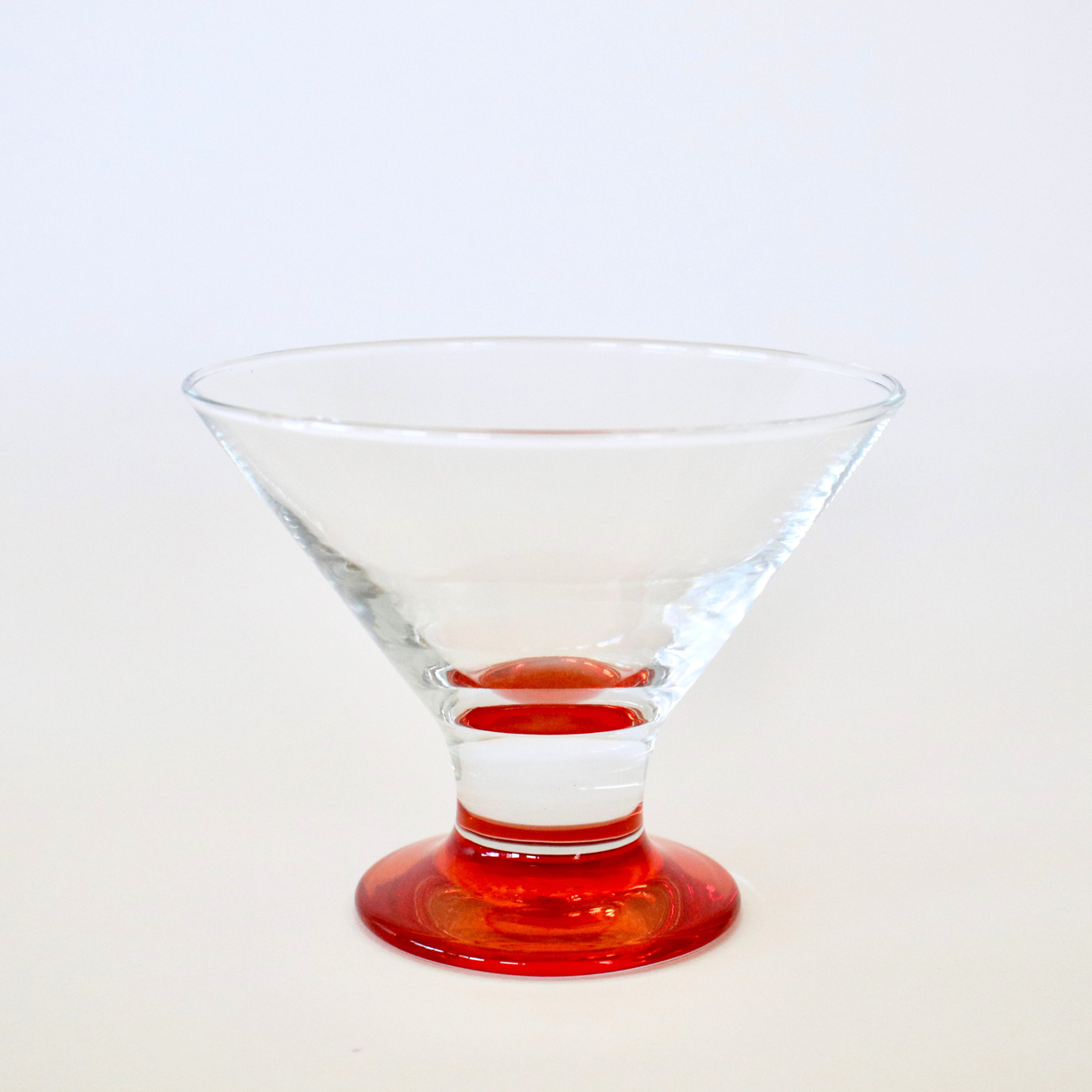 Clear glass with red base on a white background