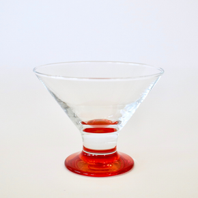 Clear glass with red base on a white background