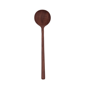 Handcrafted walnut wood spoon on white backdrop.