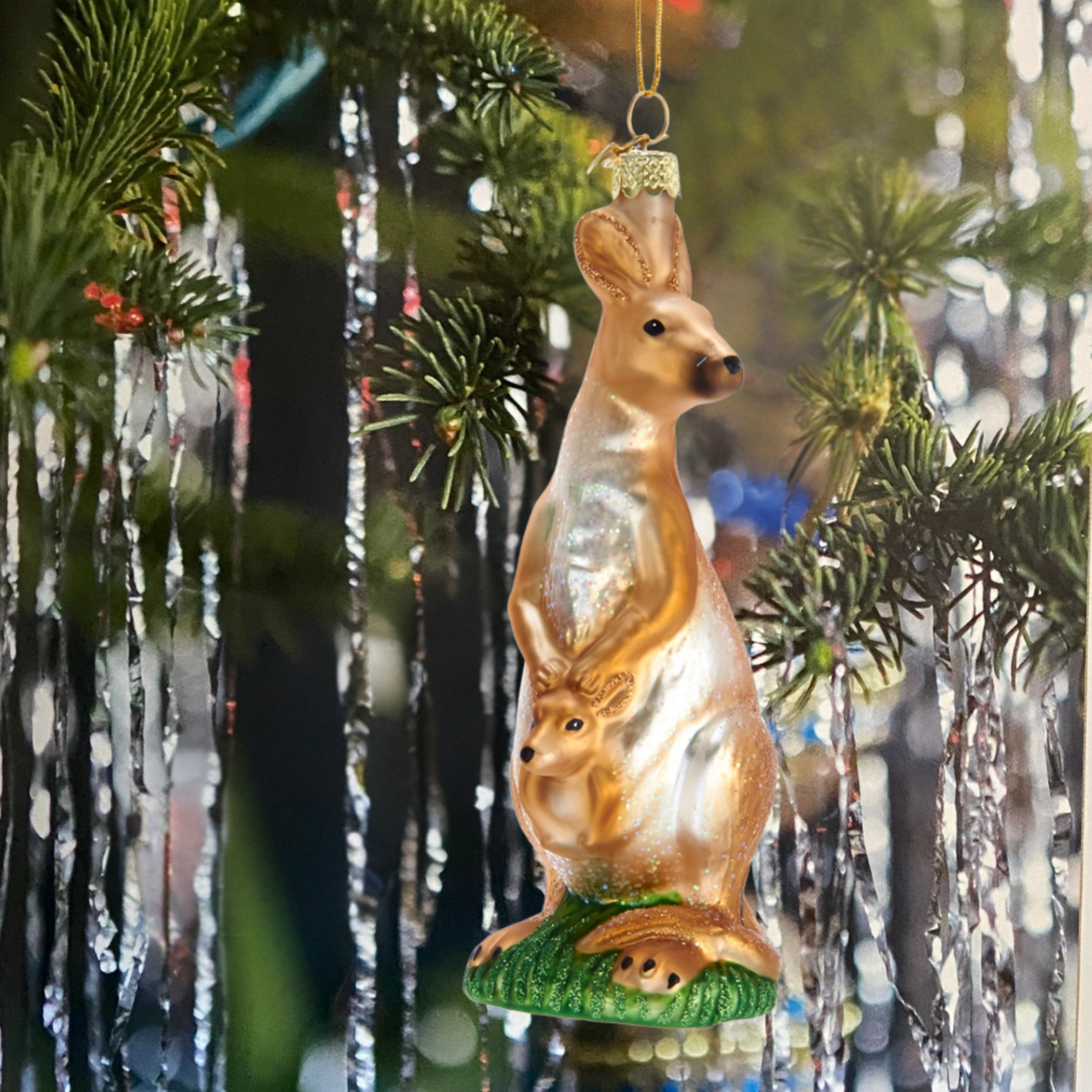 Decorative kangaroo ornament with joey on a Christmas tree.