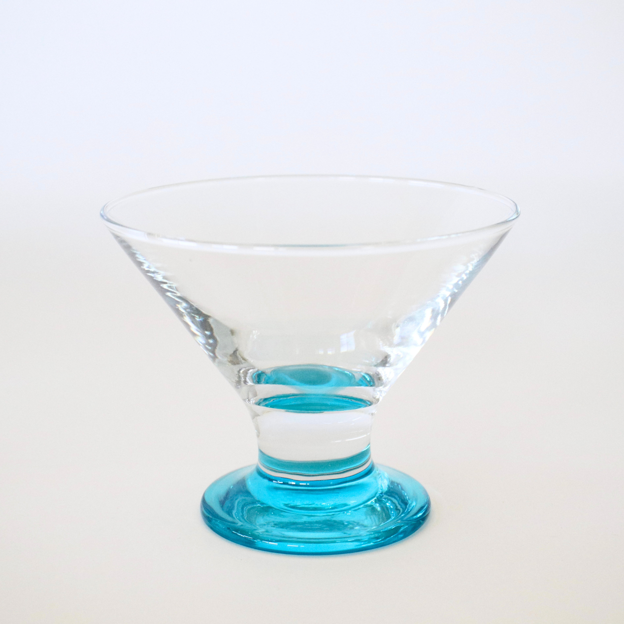 Clear glass with blue base on a white background