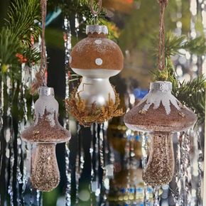 Decorative mushroom-shaped ornaments hanging on a Christmas tree.