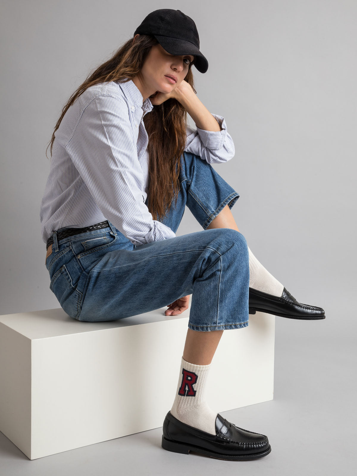 Young woman sitting wearing Royalties Paris College Socks