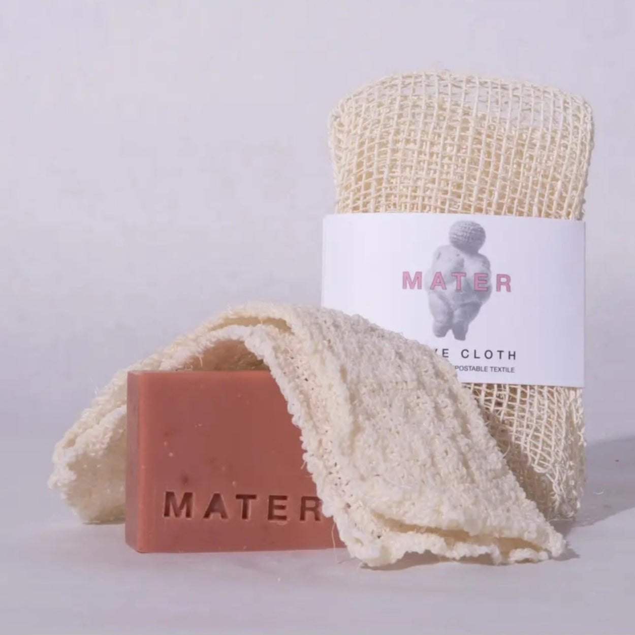 Mater pink soap and Agave Cloth wrapped and folded on grey background