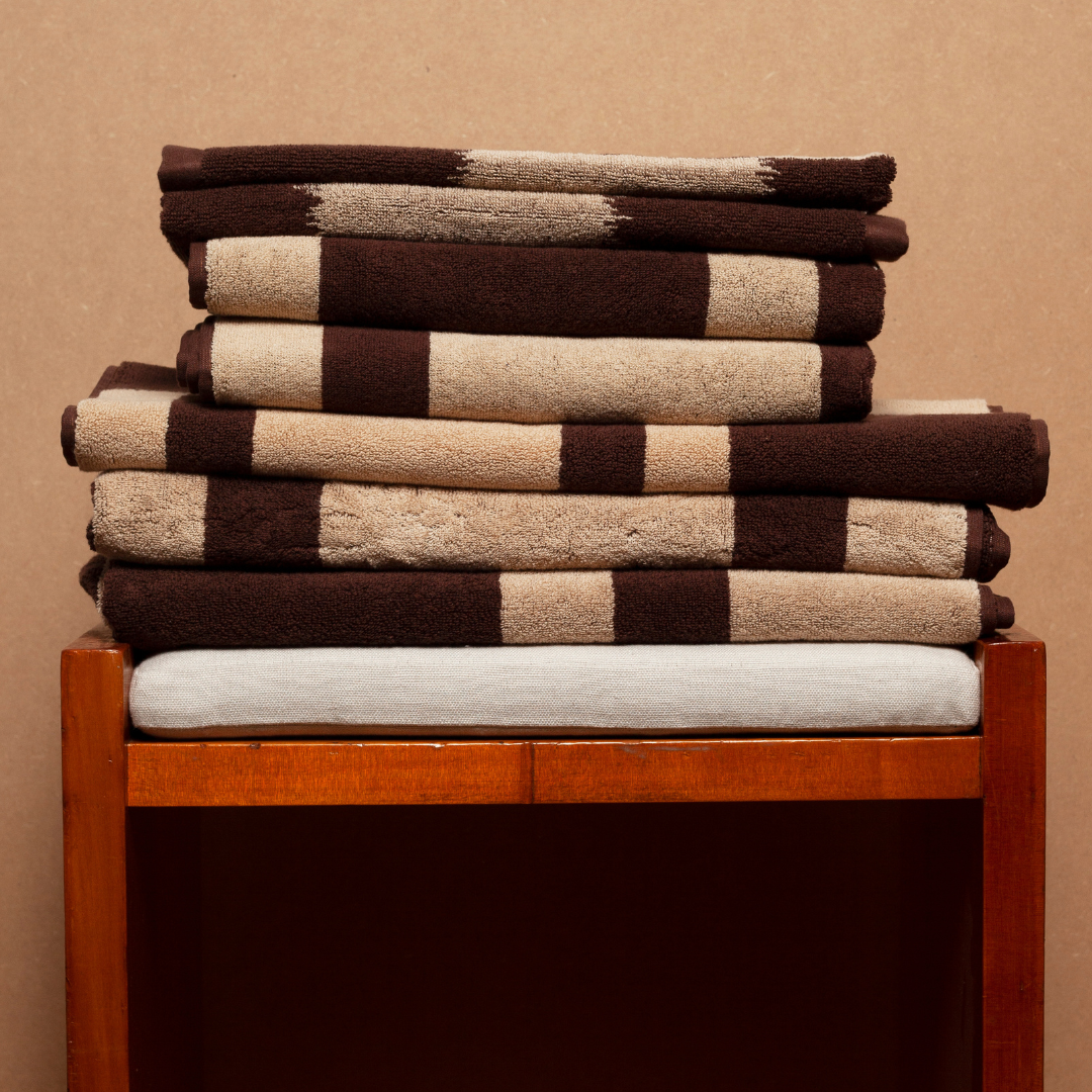 Autumn Sonata Karin towel stack on wooden stool.