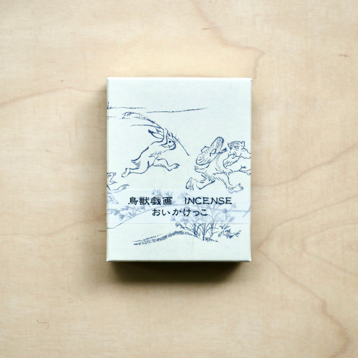 Japanese Incense Sticks - Catch box on pale wood backdrop.