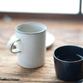 Birch mug on table with black mug.