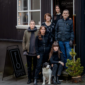 Fischersund team standing outside Icelandic store with dog.