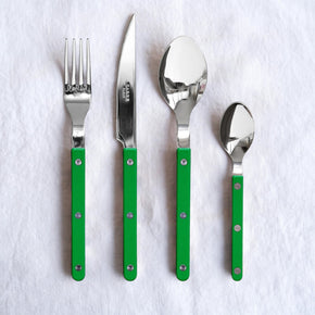 Set of stainless steel Sabre Paris cutlery with grass green handles on a white background