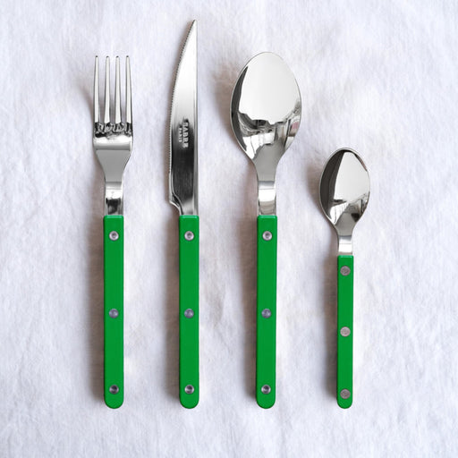 Set of stainless steel Sabre Paris cutlery with grass green handles on a white background