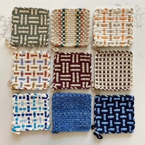 Group of 9 Kate Kilmurray pot holders on marble background