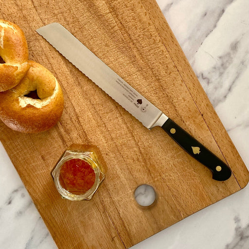 Friedr Herder Pikas 20cm Bread Knife with inlay handle on bread board with bagels and jam.