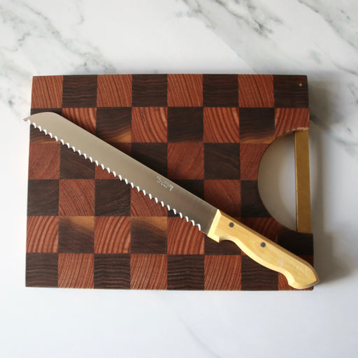 Pallares Solsona 25cm Box Wood Stainless Steel Bread Knife on wood check chopping board