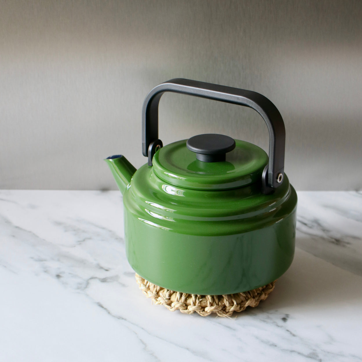 Japanese Woven Pot Holder on marble bench with green Amu kettle.